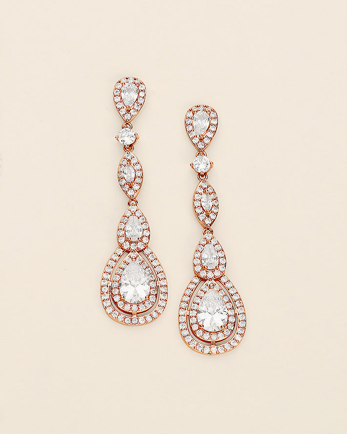 a pair of diamond earrings on a white background