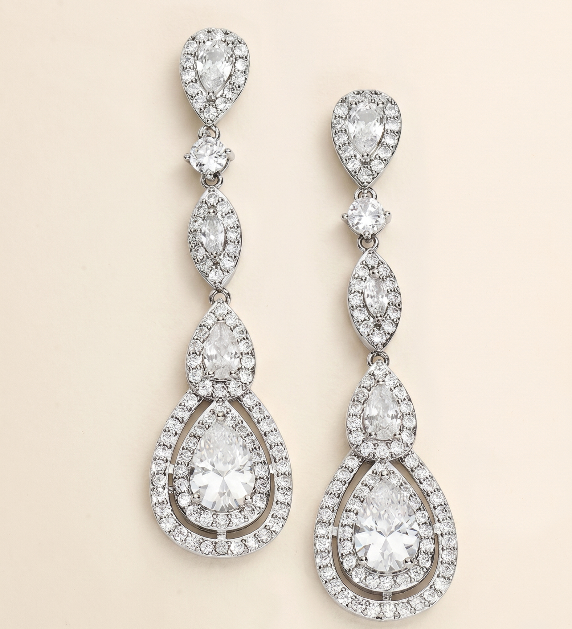 A pair of elegant diamond earrings with multiple tiers of sparkling crystal stones.
