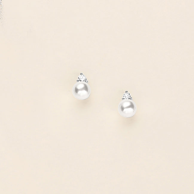 a pair of earrings on a white surface