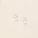 a pair of earrings on a white surface