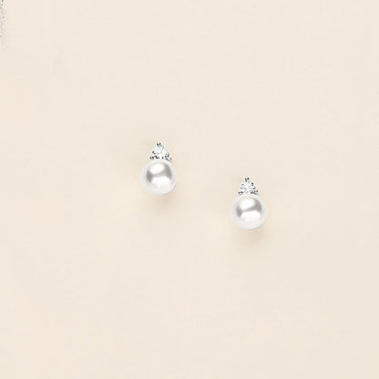 a pair of earrings on a white surface