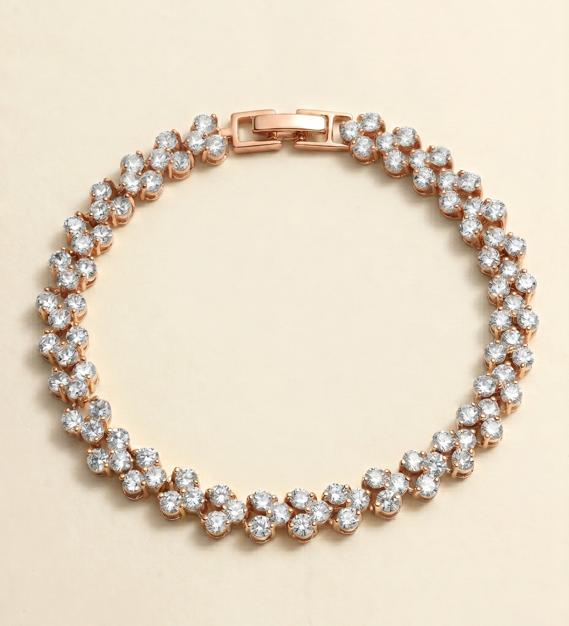 A delicate gold-toned bracelet adorned with numerous small, clear diamonds arranged in a circular pattern.