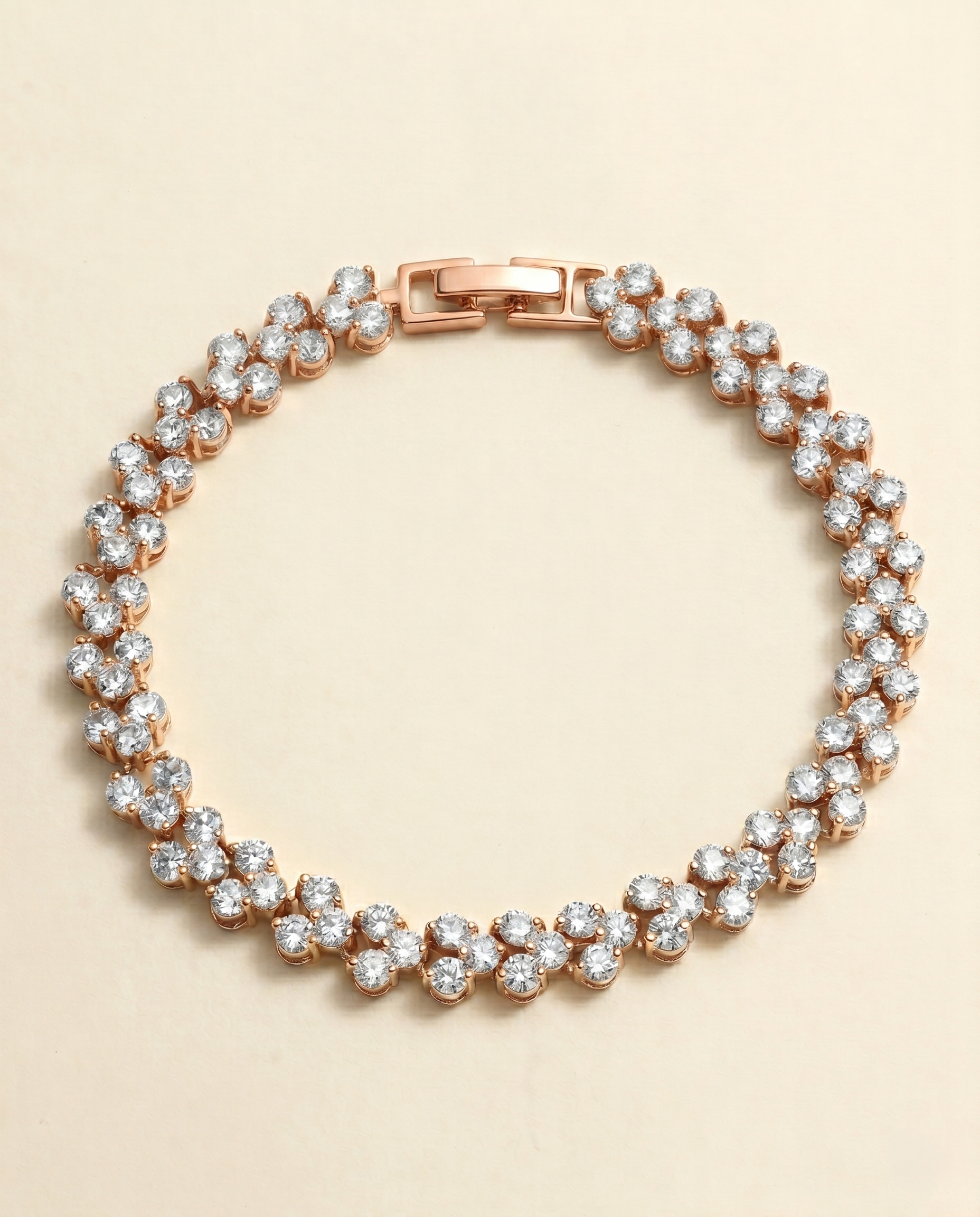 A delicate gold-toned bracelet adorned with numerous small, clear diamonds arranged in a circular pattern.