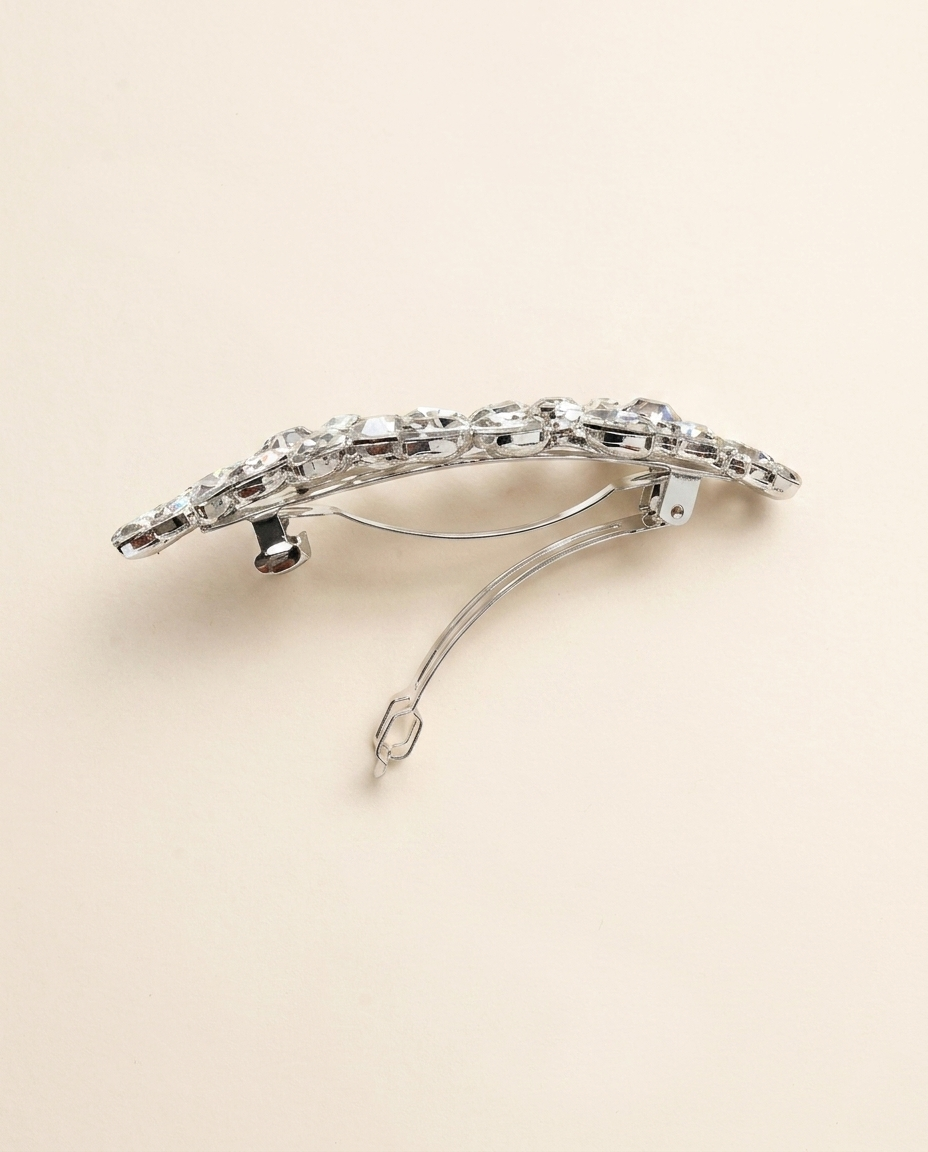A silver hair clip adorned with sparkling rhinestones.
