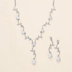 a collection of elegant jewelry pieces, including a necklace, earrings, and a bracelet, all adorned with sparkling diamonds and leaves.