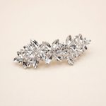 A decorative hair clip made of small, clear, and sparkling crystals.