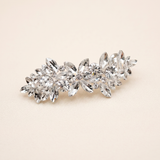 A decorative hair clip made of small, clear, and sparkling crystals.