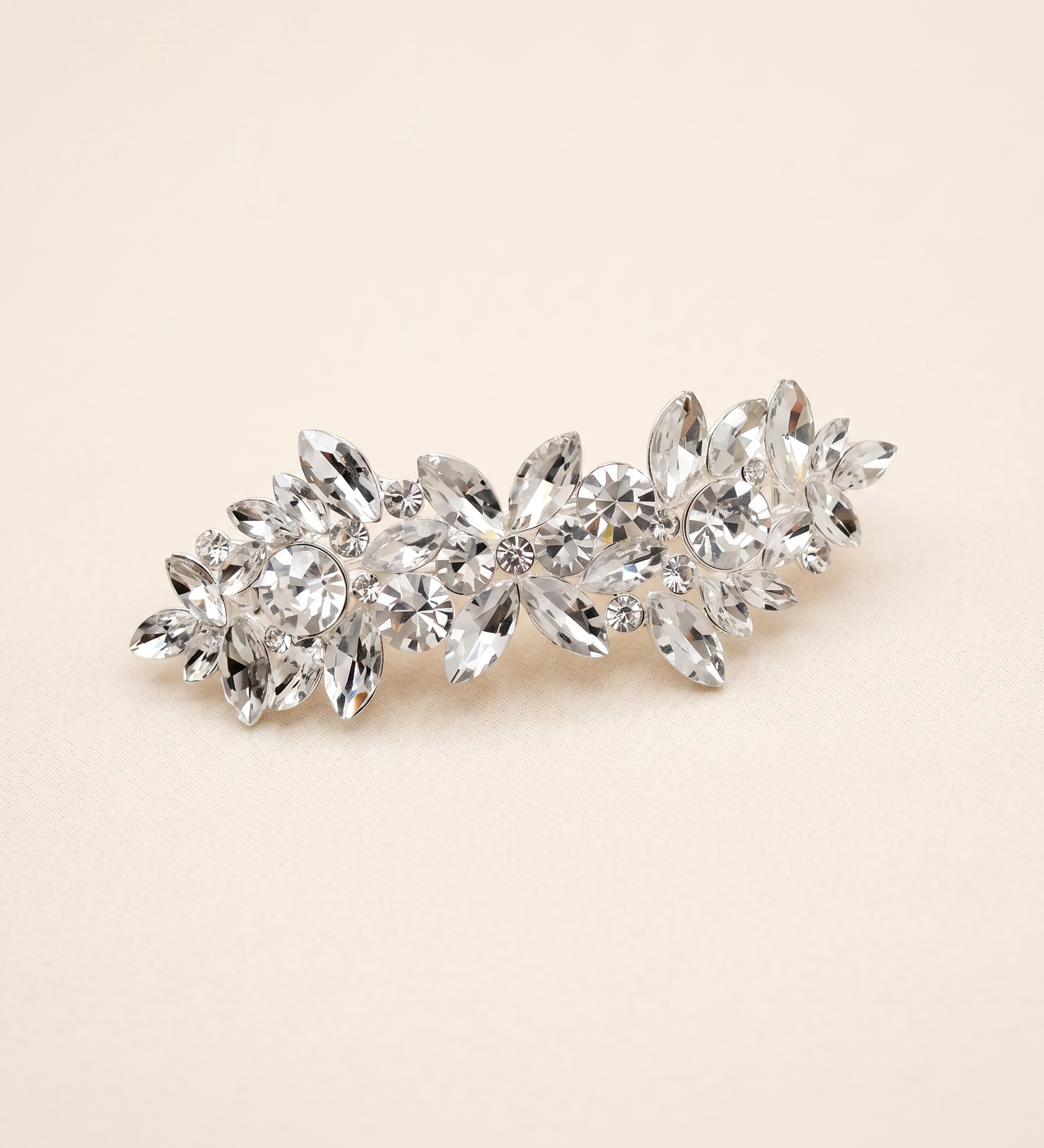 A decorative hair clip made of small, clear, and sparkling crystals.