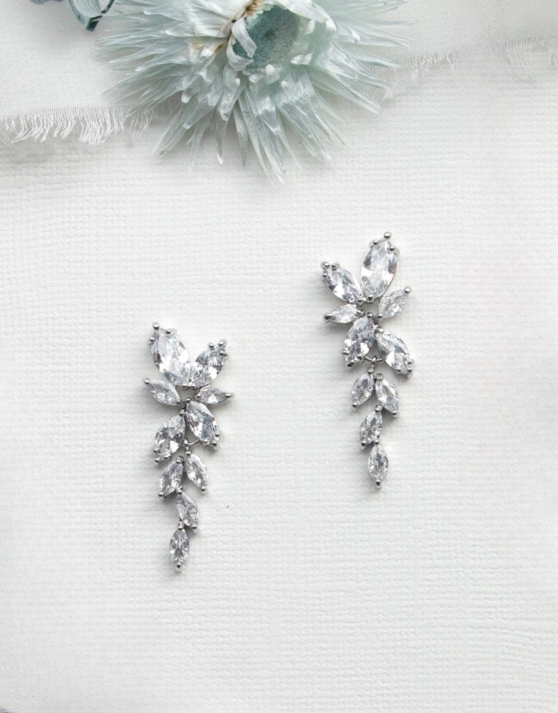 a collection of elegant jewelry pieces, including a necklace, earrings, and a bracelet, all adorned with sparkling crystal stones.