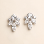 A pair of elegant diamond earrings with multiple large, clear gemstones set in a floral design.