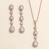 a set of elegant jewelry pieces, including a necklace and earrings, both adorned with large, sparkling diamonds.