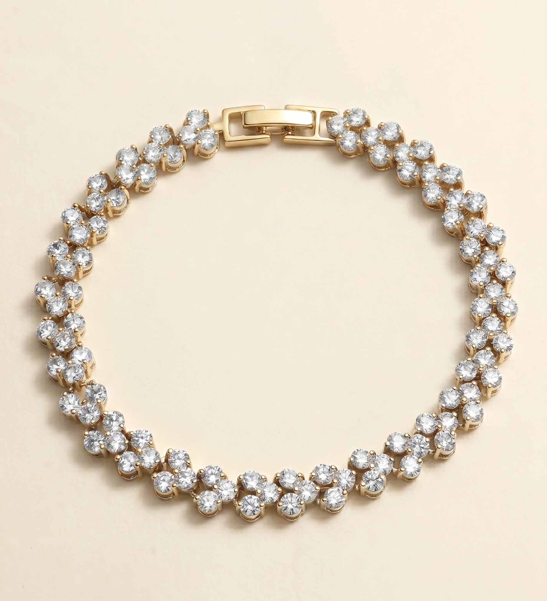 A gold-colored bracelet adorned with numerous small, clear diamonds arranged in a circular pattern.