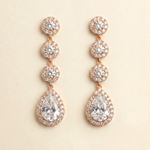 A pair of elegant gold earrings with a large, clear gemstone at the center, surrounded by smaller diamonds.