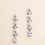 A pair of elegant earrings with pearls and crystals, featuring a row of pearls and a single crystal at the end of each earring.