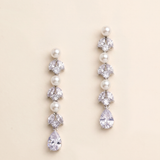 A pair of elegant earrings with pearls and crystals, featuring a row of pearls and a single crystal at the end of each earring.
