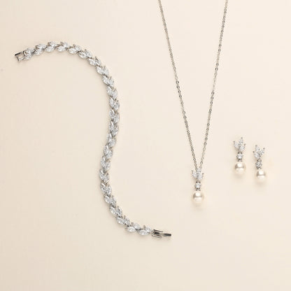 a necklace, earrings, and bracelet on a white surface