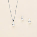 a necklace, earrings, and ring on a white background
