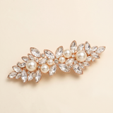 A decorative hair clip adorned with numerous crystal and pearl embellishments.