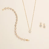 a necklace, earrings, and bracelet on a white surface