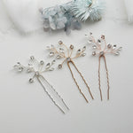 three different types of hair pins on a white surface
