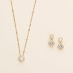 a necklace and earring set on a white surface