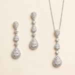 a set of elegant jewelry pieces, including earrings and a necklace, both adorned with numerous sparkling diamonds.