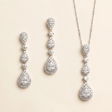 a set of elegant jewelry pieces, including earrings and a necklace, both adorned with numerous sparkling diamonds.