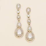 a pair of diamond earrings on a white background
