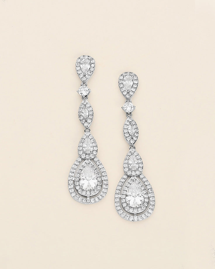 a pair of diamond earrings on a white background