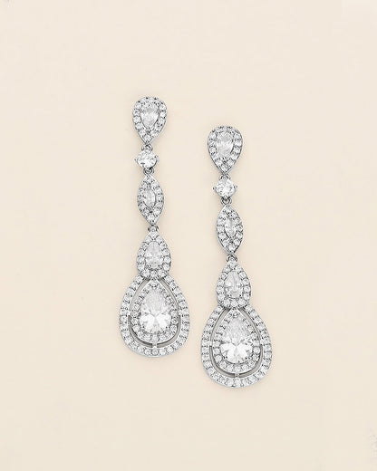 a pair of diamond earrings on a white background