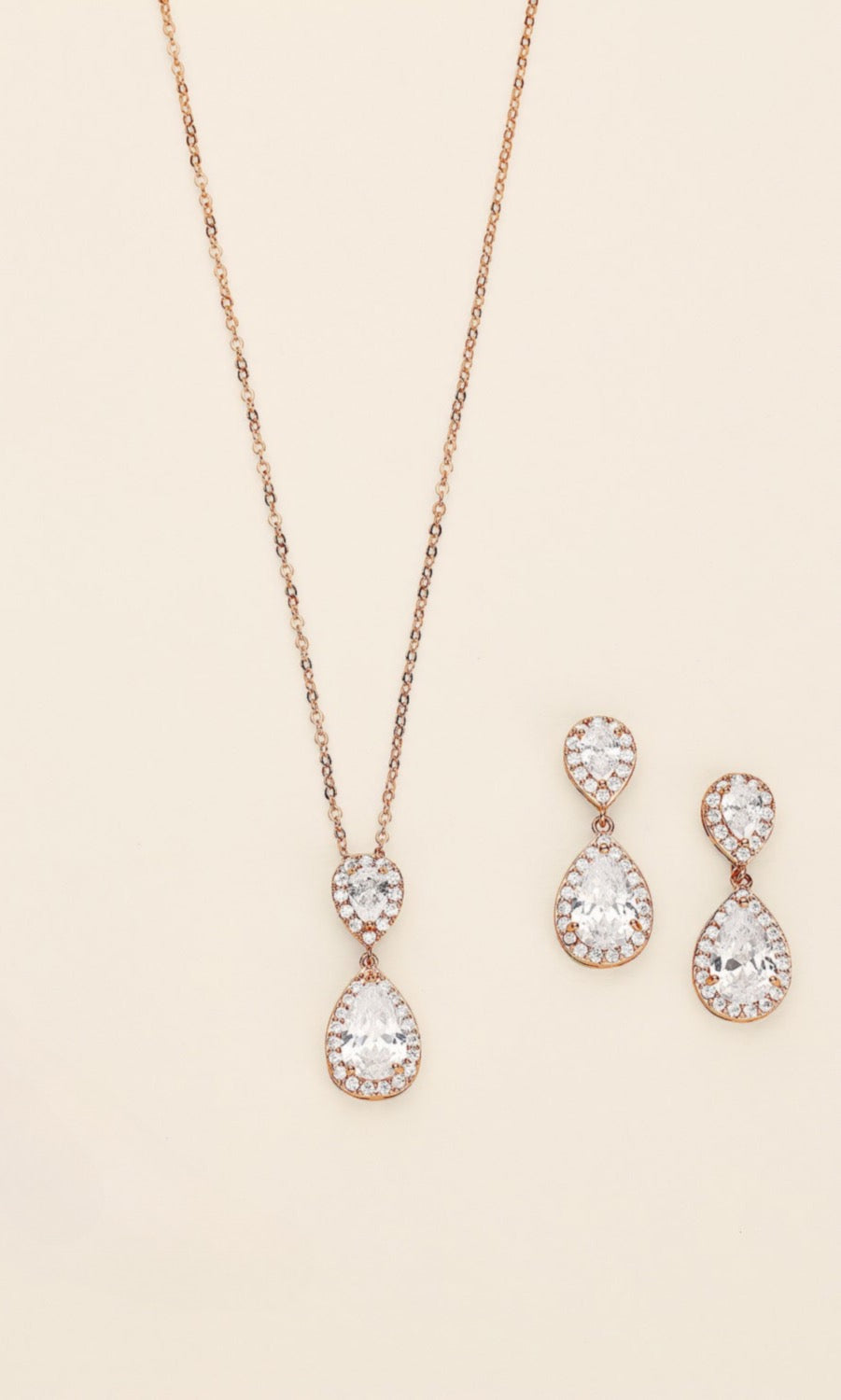 a necklace, bracelet, and earrings on a white surface