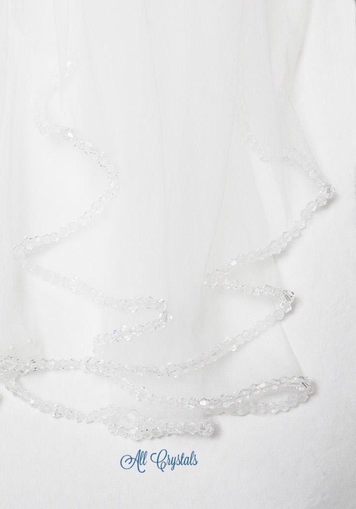 a delicate white veil adorned with small, clear crystals.