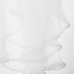 a delicate white veil adorned with small, clear crystals.