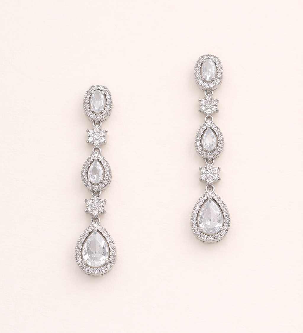 A pair of elegant earrings with multiple tiers of small, clear gemstones set in a metallic frame.