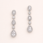 A pair of elegant earrings with multiple tiers of small, clear gemstones set in a metallic frame.