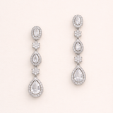 A pair of elegant earrings with multiple tiers of small, clear gemstones set in a metallic frame.
