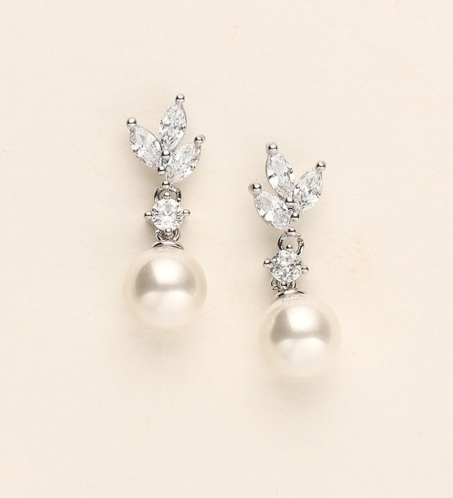 a pair of pearl and diamond earrings