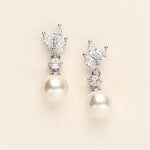 a pair of pearl and diamond earrings