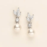 a pair of pearl and diamond earrings