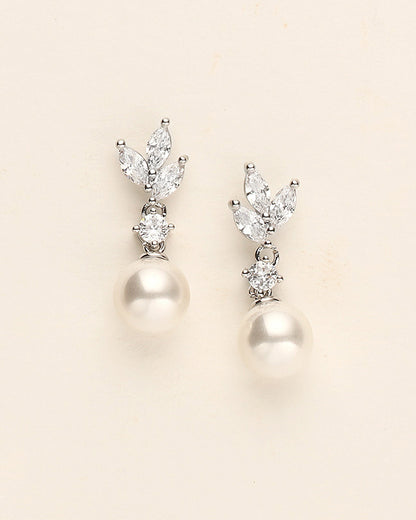 a pair of pearl and diamond earrings