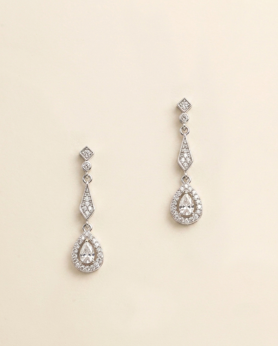 A pair of elegant earrings with a diamond-encrusted design, featuring a central pendant surrounded by smaller diamonds.