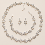 A delicate necklace and earrings set adorned with small, sparkling crystal leaves and pearls.