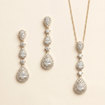 a set of elegant jewelry pieces, including earrings and a necklace, both adorned with numerous sparkling diamonds.