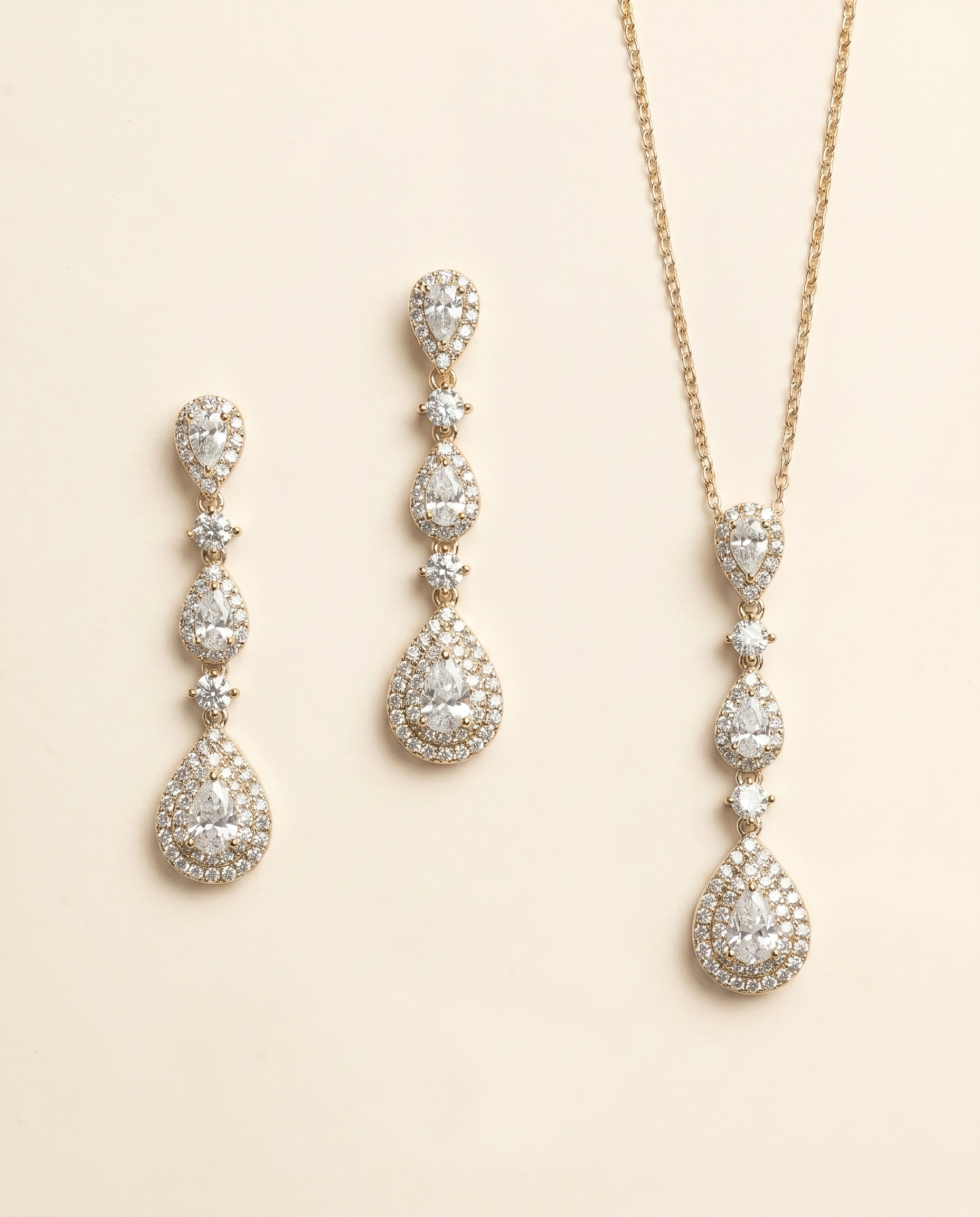 a set of elegant jewelry pieces, including earrings and a necklace, both adorned with numerous sparkling diamonds.