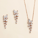 a set of elegant jewelry pieces, including earrings and a necklace, featuring delicate and intricate designs.