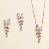 a set of elegant jewelry pieces, including earrings and a necklace, featuring delicate and intricate designs.