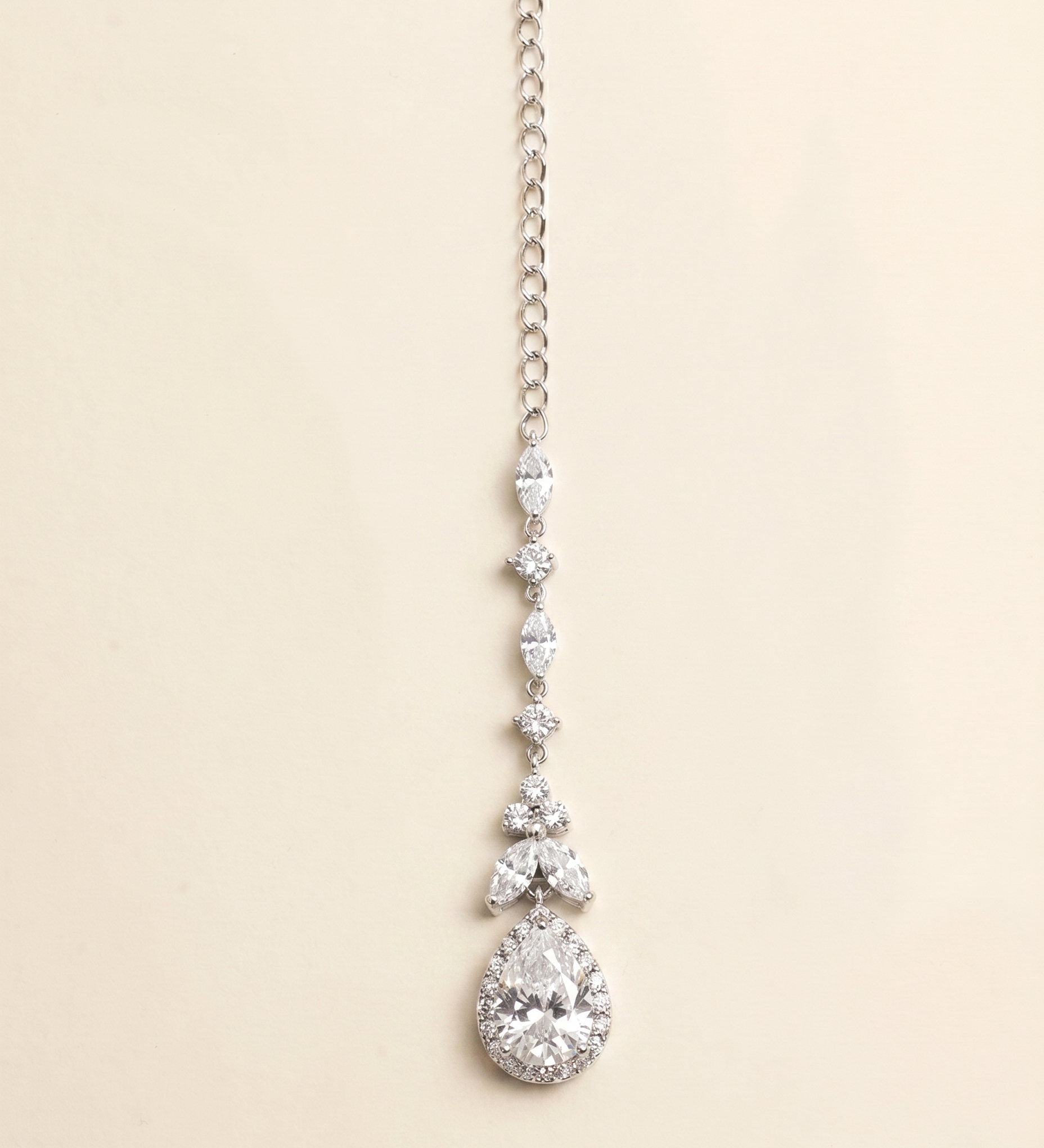 A necklace with a large, sparkling diamond pendant hanging from a chain.