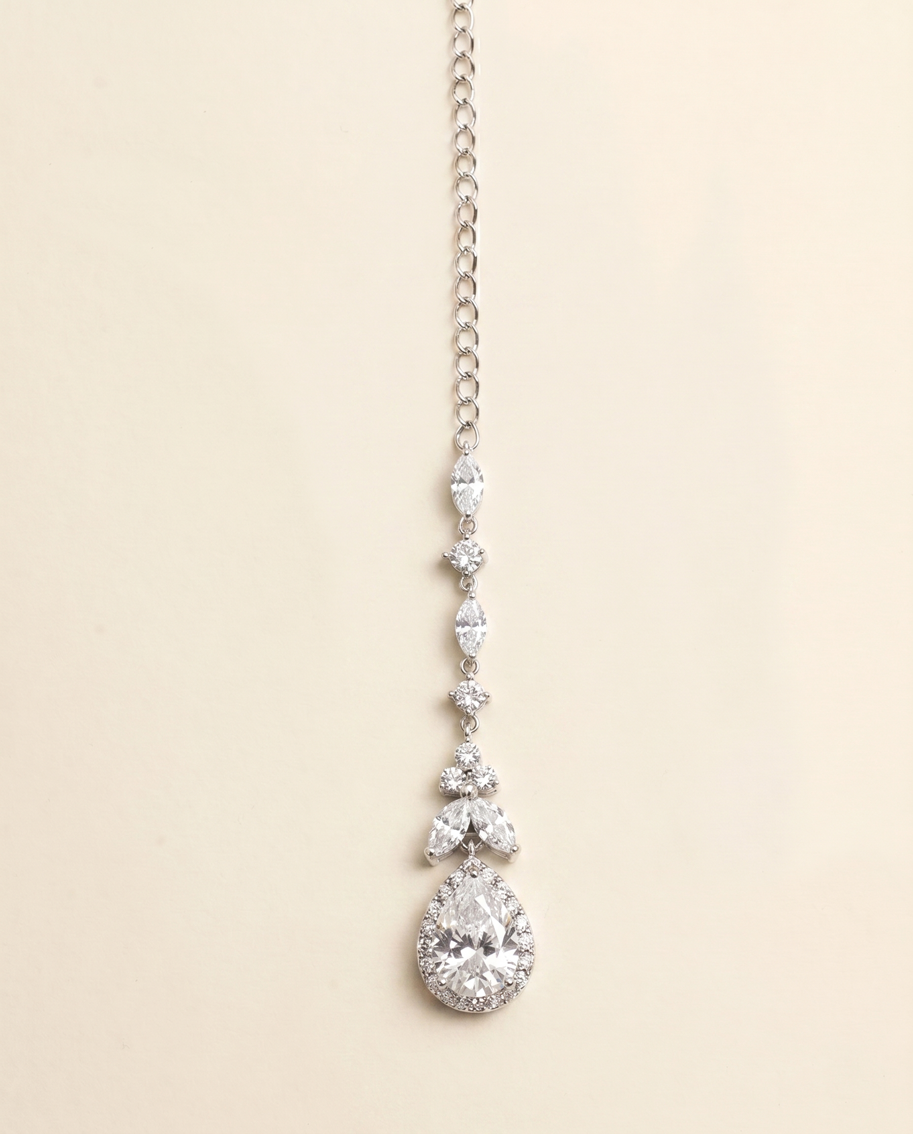 A necklace with a large, sparkling diamond pendant hanging from a chain.