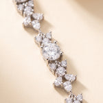 A close-up view of a delicate necklace with numerous sparkling diamonds arranged in a delicate pattern.