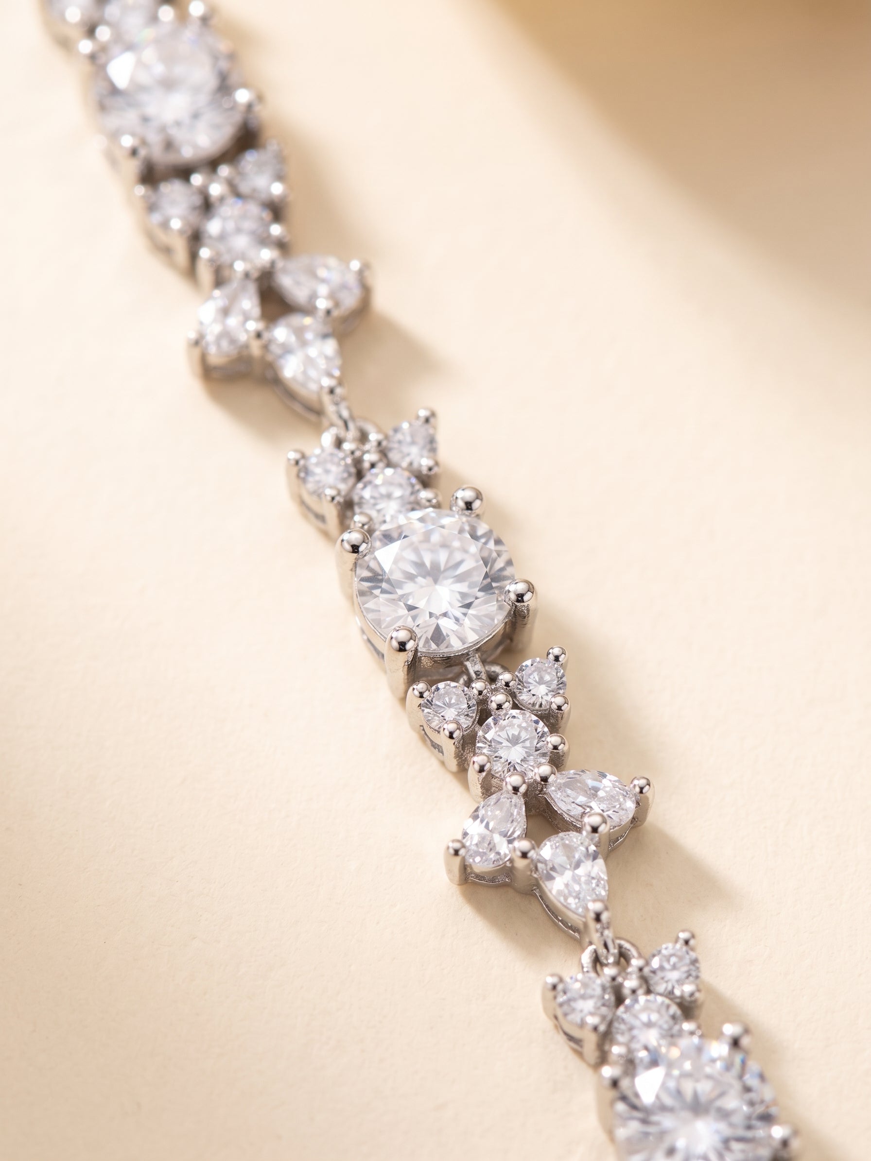 A close-up view of a delicate necklace with numerous sparkling diamonds arranged in a delicate pattern.